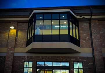 Image of outside of library building with ghost standing in window